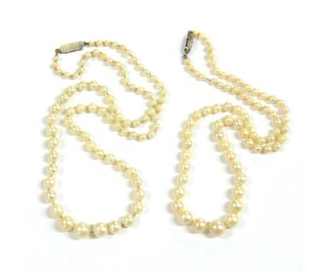 Two graduated cultured pearl necklaces, both with clasps marked sterling, and nine loose pearls