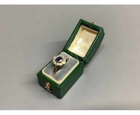 An 18ct, sapphire and diamond set oval cluster ring,size M, gross 2.8 grams.