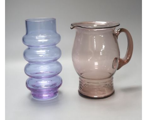 An Art glass pale amethyst jug with ribbed foot and a pale blue glass cylindrical ring-form vase, height 21cm