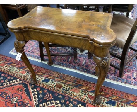 A Queen Anne revival walnut concertina folding card table, stamped Gill and Reigate, London retailed by S &amp; H Jewell, wid