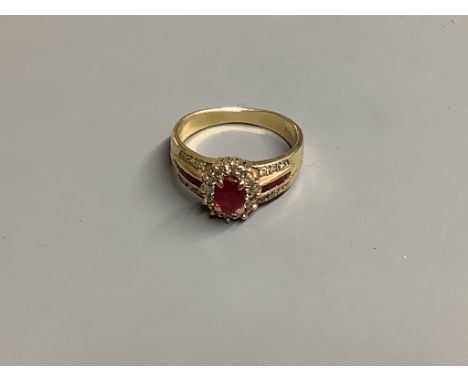 A modern 14 K yellow metal, ruby and diamond cluster ring, size M, gross 3.9 g.