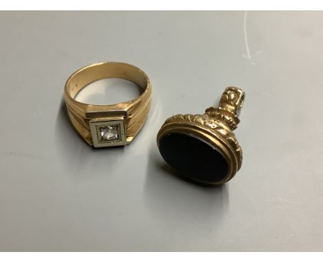 A yellow metal and paste? set signet ring, size U/V, gross weight 14 .1 g, together with a yellow metal overlaid and black on