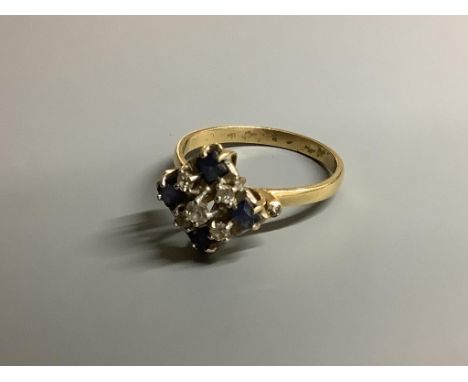 An 18ct, sapphire and diamond cluster ring, size N, gross 3.1 g.