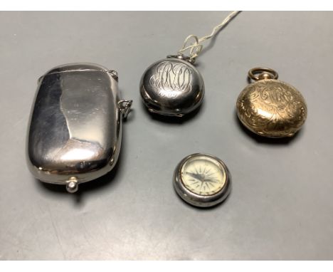 A late Victorian silver sovereign case, a gold plated sovereign case, a plated sovereign/vesta case and a compass.