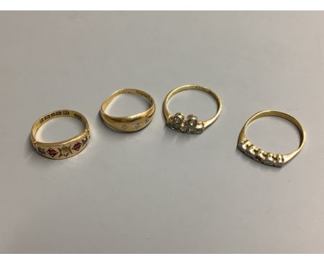 Three assorted 18ct and diamond set dress rings, gross 7.2 grams,and a 15ct and gem set ring, gross 2.2grams.