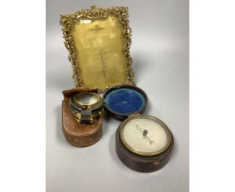A pocket barometer, a compass, a 19th century desk stand and a photograph frame