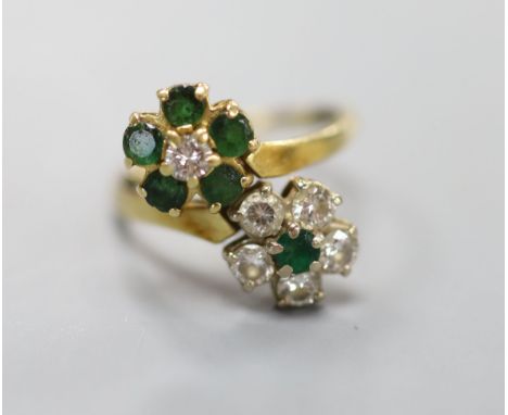 An 18ct, emerald and diamond double flowerhead cluster ring, size M, gross 4.5 grams.