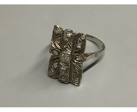 A mid 20th century 18ct white metal and diamond cluster set tablet ring,size Q, gross 4 grams.