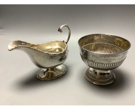 A late Victorian demi fluted silver sugar bowl, Chester 1899, and an Edwardian silver pedestal sauceboat, London, 1901, 13.5 