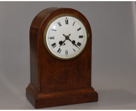 An Edwardian mantel clock, the domed mahogany case with satinwood stringing, the white enamel dial with Roman numerals, with 