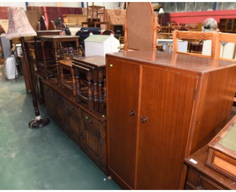 A group of furniture comprising an oak linenfold carved sideboard, an oak nest of tables, oak occasional table, oak low table