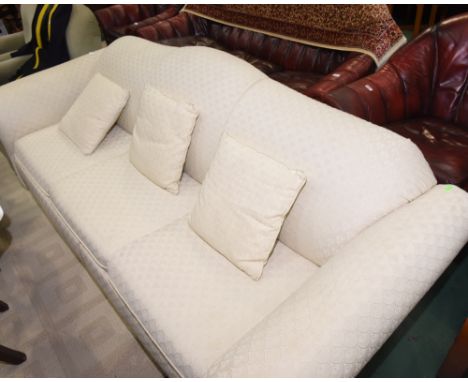 A three seater sofa bed with cream upholstery