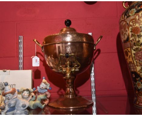 A brass and copper tea urn in the Arts & Crafts taste, with ebonised wooden knop, and stylised floral decoration, raised on a