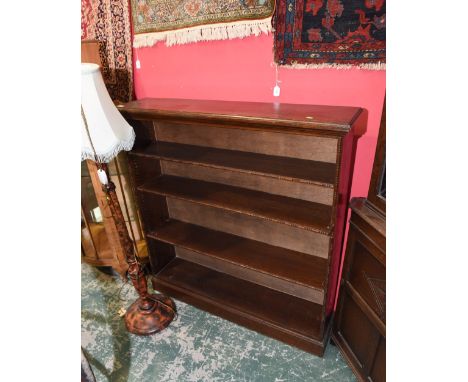 An oak open bookcase; tog. with a standard lamp