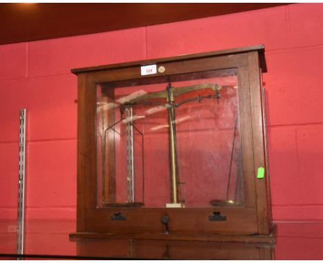 A set of brass scales, Philip Harris of Dublin & Birmingham, in a glazed oak case