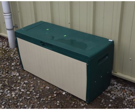 A green plastic storage trunk