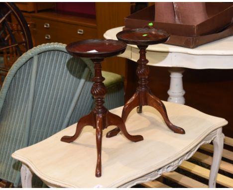 A pair of period style mahogany tripod tables