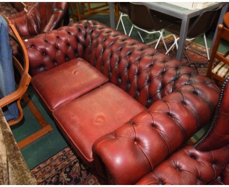 A red leather sofa of Chesterfield type