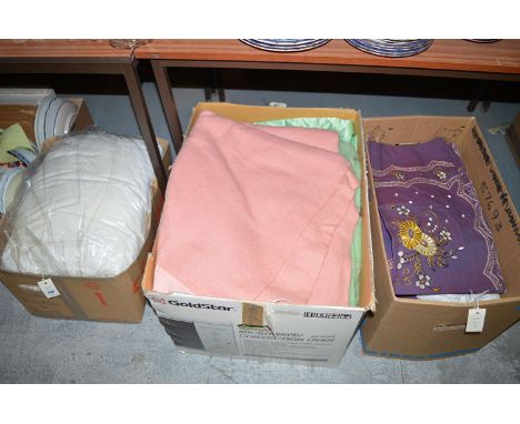 A quantity of soft goods, to include: bed linen; curtains; etc., in three boxes.