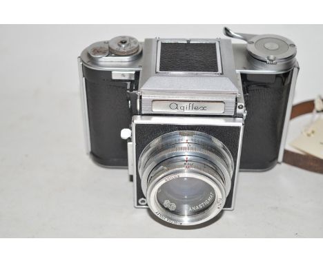 An Agiflex medium format reflex camera, fitted an Agilux 80mm f2.8 lens; in brown leather case and strap.