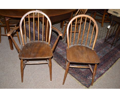 A set of four plus two Ercol stained wood dining chairs with solid elm seats, raised on turned legs joined by stretchers.