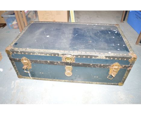 A large vintage travelling trunk with leather and metal bindings.