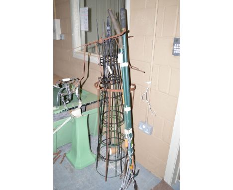 A bundle of garden tools; and a quantity of metal plant supports.