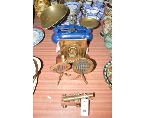 A set of Salters kitchen scales and weights; a pair of miniature brass tables and fireplace; together with a small miniature 
