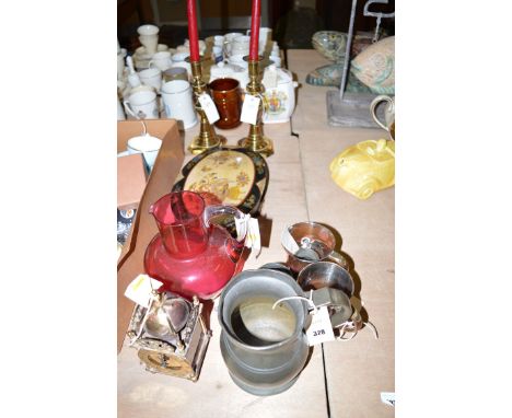 A large cranberry glass jug; a reproduction lantern style clock; five metal tankards, various; an oval papier mache box; and 