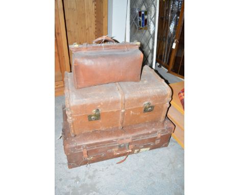 A leather Gladstone bag; a large leather trunk; and another trunk with wooden metal bindings.
