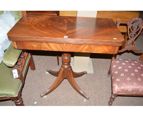 A reproduction mahogany turnover top card table, with tooled leather playing surface, raised on a turned column with four spl