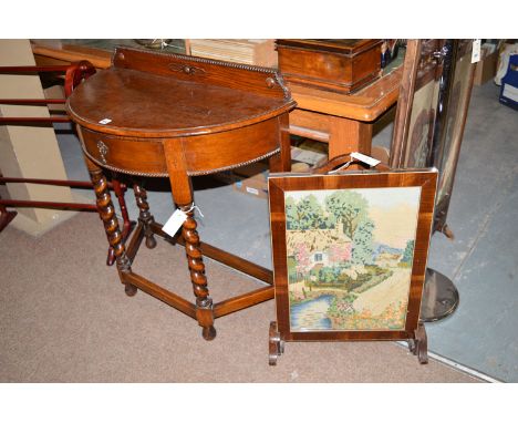 A mid 20th Century semi circular oak hall table, fitted a single drawer to the frieze, raised on spiral twist legs joined by 