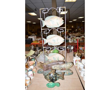 Three modern painted wooden fish ornaments; and a ceramic and metal fish ornament.