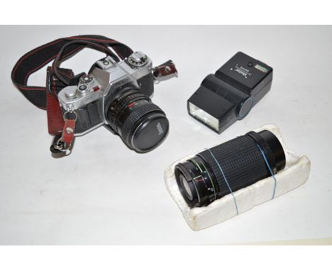 A Canon AV-I 35mm SLR camera with two lenses; a flash unit, instruction manual; various other accessories including a tripod;