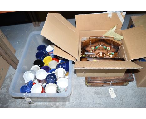 A collection of advertising mugs; a modern German cuckoo clock; together with two wooden trays.