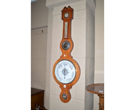A 19th Century mercury barometer in a mahogany banjo pattern case, the white enamel dial also fitted a thermometer, a convex 