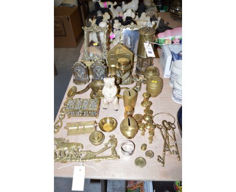 A collection of brass ornaments; weights; picture frames; a miner's lamp; Durham Cathedral door knocker bookends; a nutcracke