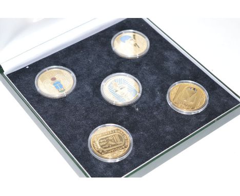 A collection of gilt and enamel silver commemorative coins, from 'The Treasures of Tutankhamun', set by the London Mint Offic