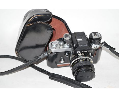 A Nikon F2 SLR camera fitted photomic prism finder, flash-shoe and Nikkor 35mm f2.8 lens; in leather ER case.