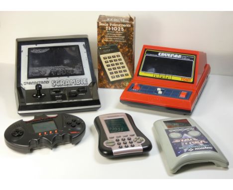 Six electronic handheld devices, five games and a calculator, to include : Scramble Captain Caveman Batman and Robin (with Ba
