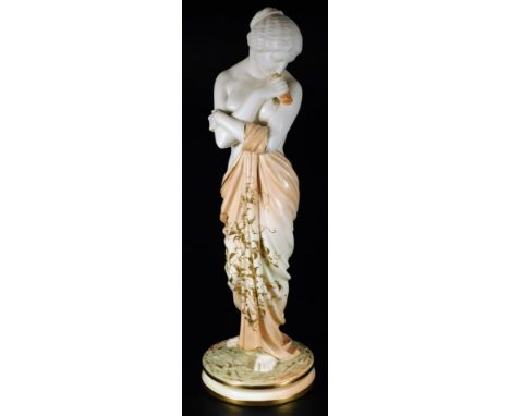 A early 20thC Royal Worcester blush ivory figure of Joy, semi clad in standing pose, on an inverted circular base, c1906, 43c