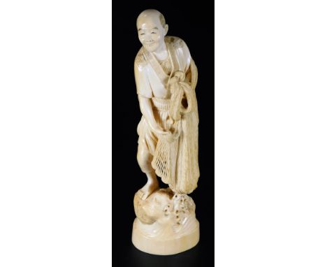 A  Japanese Hidemitsu Meiji period ivory figure, of a fisherman in flowing robes holding net, on a naturalistic base, red sea