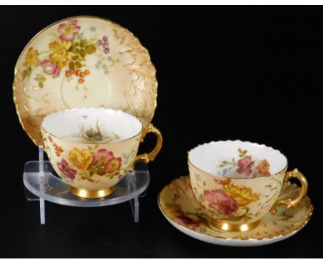 A pair of 19thC Royal Worcester blush ivory cups and saucers, each decorated with flowers with gilt highlights, no.1565, c189