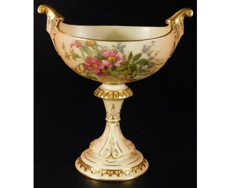 An early 20thC Royal Worcester blush ivory centrepiece, with oval bowl, flanked by scroll handles on an inverted stem and dom