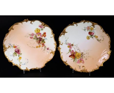 A pair of late 19thC Royal Worcester blush ivory plates, handpainted with flowers with gilt highlights, no. W4779, c1895.  (2