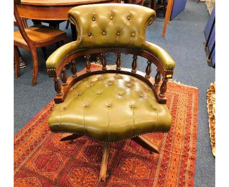 A green leather button back captain's swivel chair