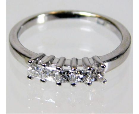 An 18ct gold ring set with five princess cut diamonds 2.8g size L/M