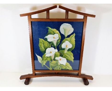 A stylishly designed firescreen with white calla lily flowers 29.5in high