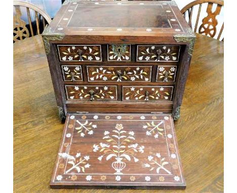 A 18thC. Indo Portuguese bone inlaid rosewood & walnut spice cabinet with brass bound corners & plates to sides comprising ei