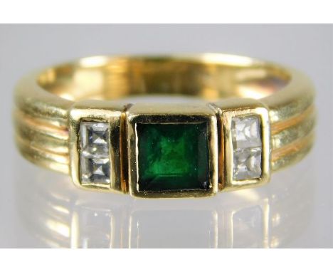 An 18ct gold art deco style emerald ring set with princess cut diamonds on shoulders 5.6g size N/M